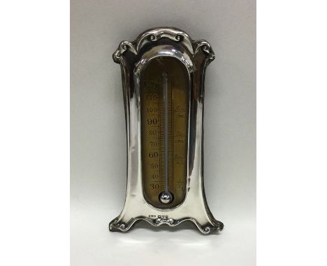 A rare Chester silver mounted thermometer with scroll decoration. 1902. By E Trevett. Approx. 86 grams. Est. £60 - £80.