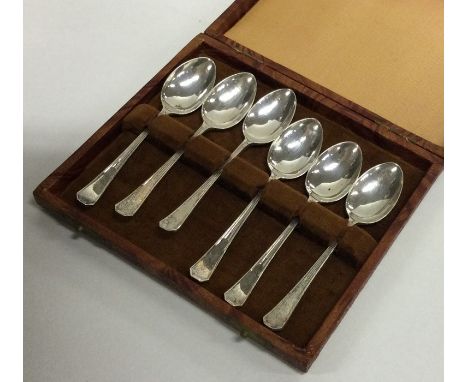 A cased set of six silver engine turned teaspoons. Sheffield. Approx. 60 grams. Est. £20 - £30.