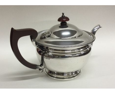 An Edwardian silver teapot. Birmingham 1936. By Asprey &amp; Co. Approx. 418 grams. Est. £100 - £150.