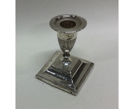 An Edwardian silver candlestick on spreading foot. London. Approx. 160 grams. Est. £20 - £30.