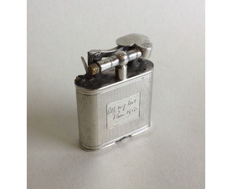 A solid silver Dunhill lighter with engine turned decoration. London 1949. Approx. 60 grams. Est. £200 - £300.
