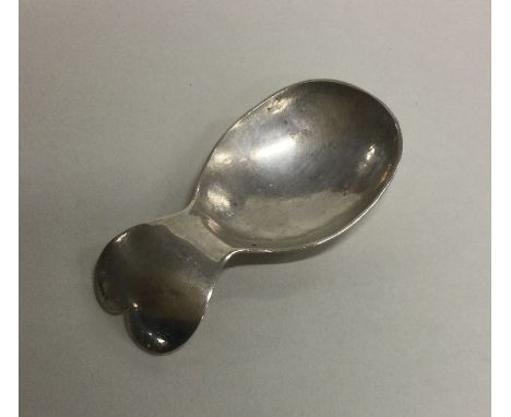 A stylish silver caddy spoon of heart shaped design. Marked Sterling. Approx. 22 grams. Est. £30 - £40.