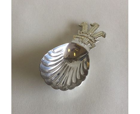 A heavy cast silver caddy spoon depicting The Prince of Wales Feathers. London. By RB. Approx. 24 grams. Est. £25 - £35.