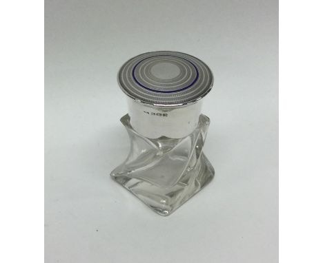 An engine turned silver and enamelled scent bottle of stylised form. Birmingham. By L&amp;S. Est. £20 - £30.