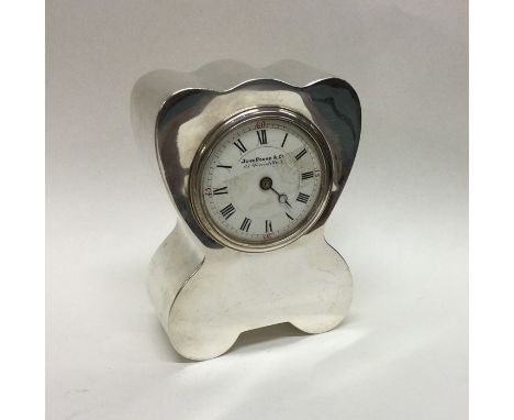 A stylish silver mantle clock of shaped form with white enamelled dial. Birmingham. By JCC. Approx. 473 grams. Est. £250 - £3