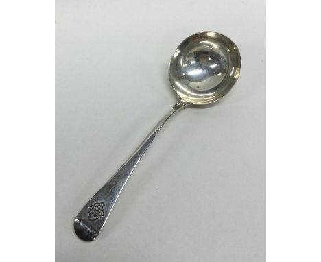 A Georgian OE pattern silver ladle with crested armorial. London. By WE. Approx. 48 grams. Est. £20 - £30.