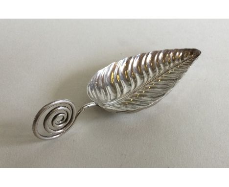 A good cast silver caddy spoon in the form of a leaf with twisted handle. Approx. 15 grams. Est. £35 - £45.