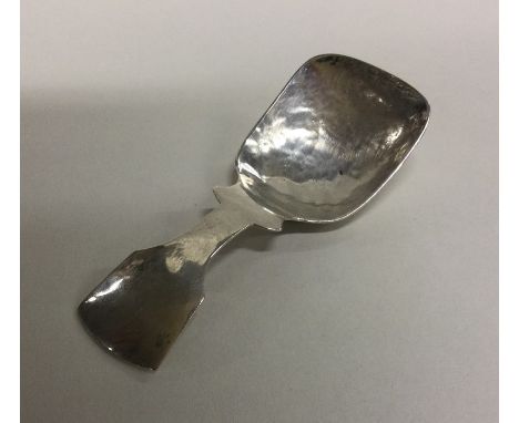 A stylish silver caddy spoon with textured bowl. Marked Sterling. Approx. 22 grams. Est. £30 - £40.