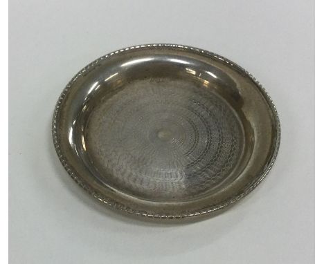 An attractive Continental silver engine turned dish. Approx. 16 grams. Est. £10 - £20.