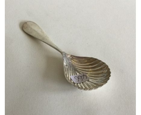 An Antique French silver caddy spoon with fluted body to crested terminal. Approx. 18 grams. Est. £35 - £45.