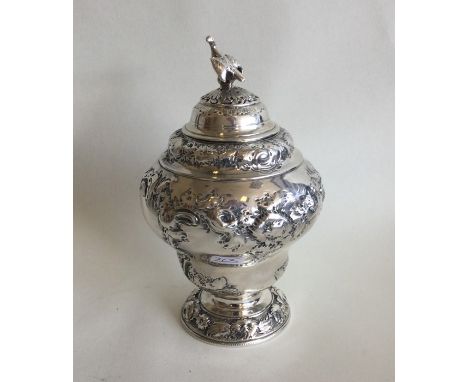 A good heavy George II silver pear shaped tea caddy / caster profusely embossed with flowers and leaves. London. By William S
