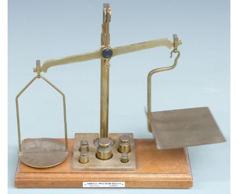 Arnold Precision Scales, Redhill, Surrey, brass postage or similar scales with weights to base, width 29cm