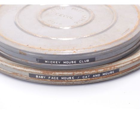 Two vintage 16mm cartoon film reels, one marked 'Mickey Mouse Club' and the other 'Baby Face Mouse/Cat and Mouse'