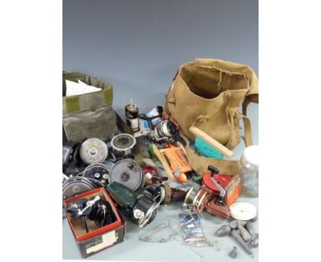 A collection of vintage fixed spool reels together with four fly reels and two multipliers plus two vintage bags and contents