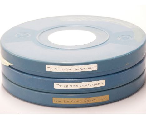 Three vintage Laurel &amp; Hardy 16mm cine film reels marked 'The Hoose Cow', 'Launching Gravy' and 'Twice Two'