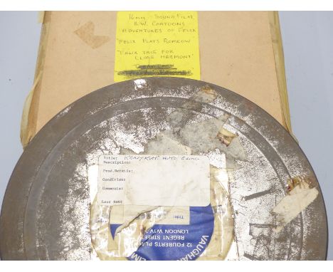 Two vintage 16mm cartoon film reels, one marked 'Krazy Kat Auto Clinic', the other 'Felix Plays Romeow / Felix Tries for Clos