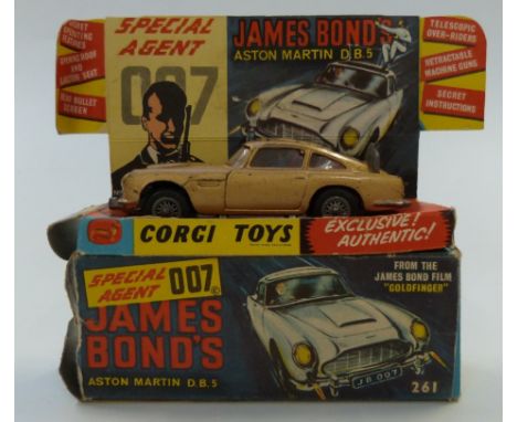 Corgi Toys diecast model James Bond 007 Aston Martin DB5 with gold body, red interior, spoked hubs and baddie figure 261, in 