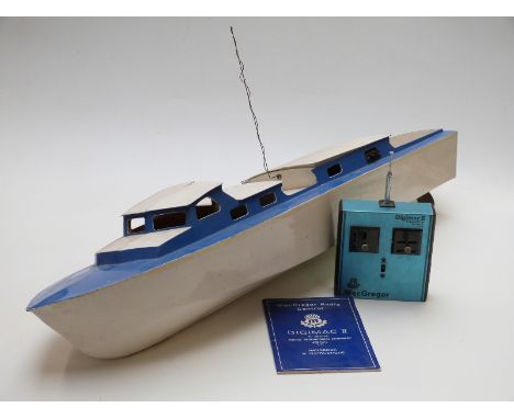 A wooden remote control model boat with MacGregor Digimac II transmitter and control manual, 90cm long
