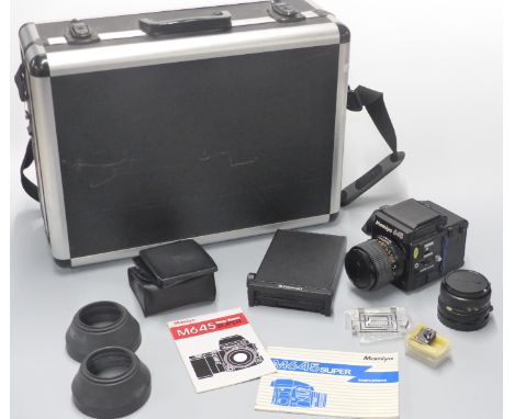 Mamiya 645 super medium format SLR camera with 80mm 1:2.8 and 110mm 1:2.8 Mamiya-Sekor lenses, Polaroid back, caps, literatur