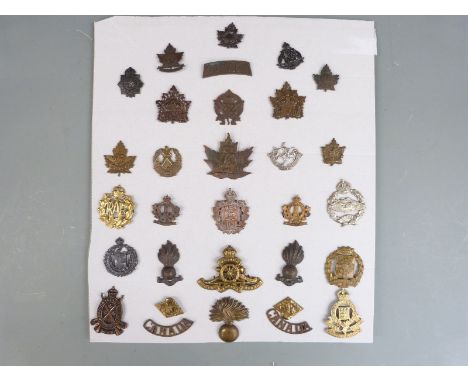 Approximately 30 WWI/WWII Canadian Army cap badges/ insignia including Cameron Highlanders, Ottawa, Canadian Infantry Corps, 