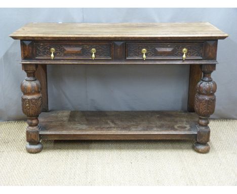 Carved oak sideboard having two drawers, supported on bulbous carved legs united by a shelf, W137 x D52 H86cm