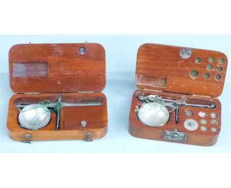 Two wooden cased sets of diamond or similar travelling scales. Width of larger case 12cm