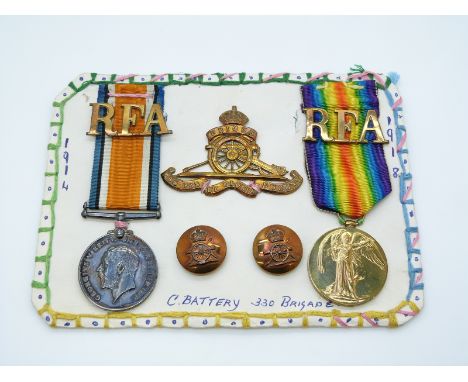 British Army WWI medals comprising War Medal and Victory Medal, named to 711538 Gunner H G Harman, RA, together with a cap ba