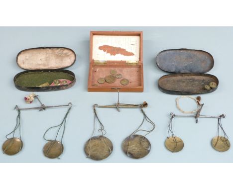 Three cased sets of travelling beam scales including apothecary and similar weights