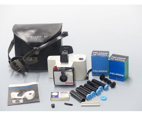 Polaroid Swinger Model 20 camera together with a quantity of accessories