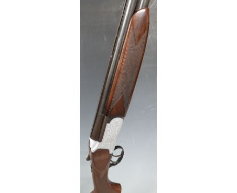Fabarm 12 bore over and under shotgun with engraved scenes of dogs to the named locks, all over scrolling engraving, double t