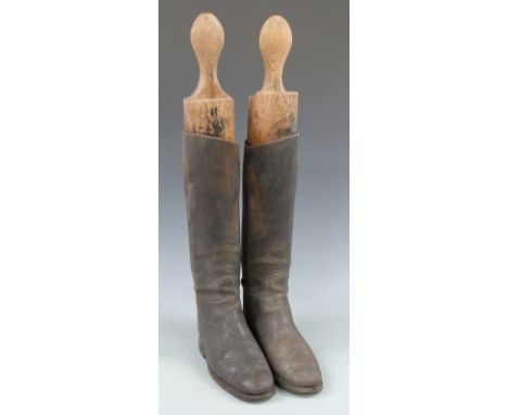 A pair of vintage leather riding boots with trees, approximately size 8