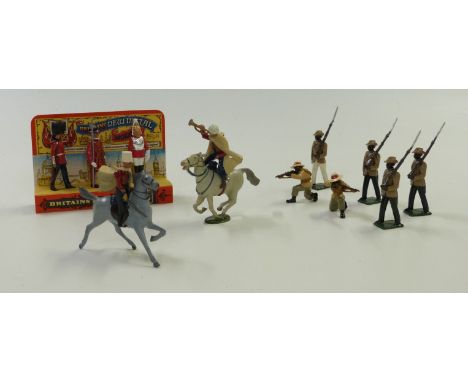 Nine Britains diecast model soldiers comprising six Gurkhas and three Queen's Guards on original stand