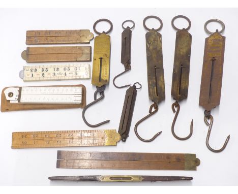 A collection of folding rulers including W M Marples &amp; Sons and Rabone Chesterman, together with various spring balance s