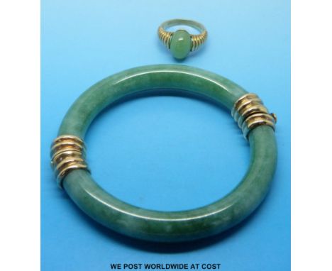 A jade bangle with 9ct gold clasps and a 9ct gold ring set with jade