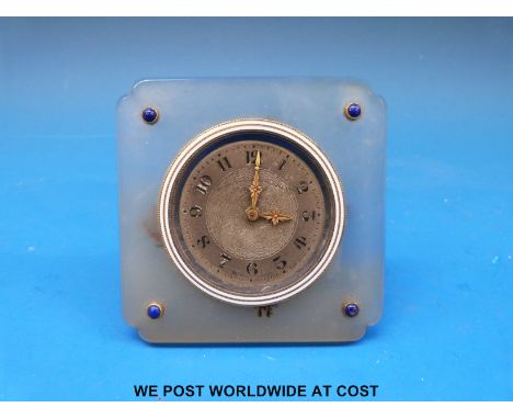 A small bedroom style clock marked 'The Goldsmiths and Silversmiths Co. 42 Regent St' mounted in an oynx case, decorated with