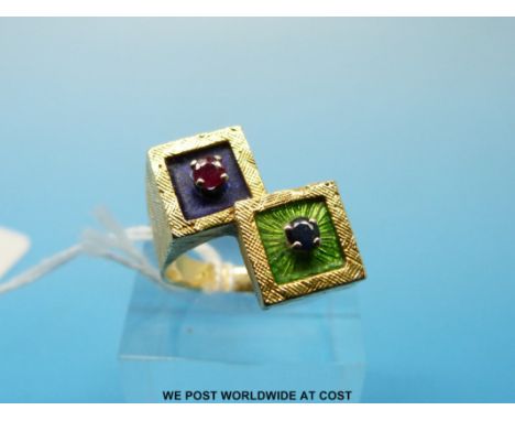 A yellow metal ring in  the form of two squares set with enamel, a ruby and a sapphire (size N, 9.5g) 