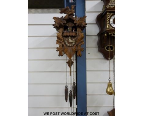 A three-train  Black Forest cuckoo clock with musical hour and half-hour, "Happy Wanderer" and "Edelweiss' 'Germany" to dial 