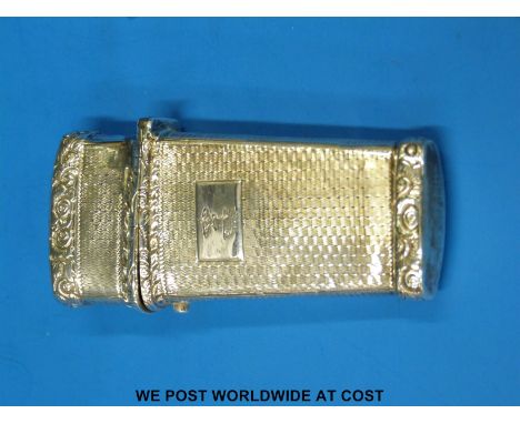 A hallmarked silver etui with engine-turned and engraved interior, opening to reveal gilt wash and four compartments, marks r