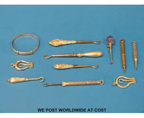 Eight hallmarked silver and other handled button hooks including two folding examples, together with a white metal bangle mar