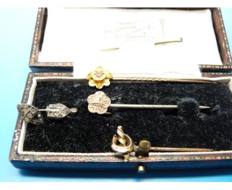 Five yellow metal and other stick pins, one marked 15ct, in vintage box 