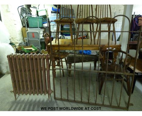 A probably 19thC wrought iron gate with hoop top together with a cast iron radiator (gate H128 x W117cm)