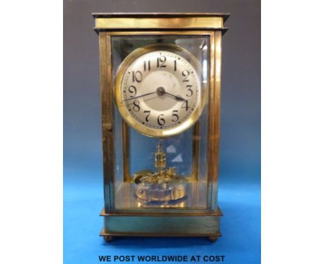 A brass and bevelled glass cased Anniversary clock with silvered dial and a fused bi-metal split ring temperature compensator