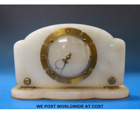 An alabaster cased mantel clock with brass dial and Art Deco moon shaped hands. 