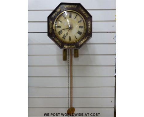 A Georgian octagonal shaped wall clock with two-train movement set in wooden frames and face with brass inlay