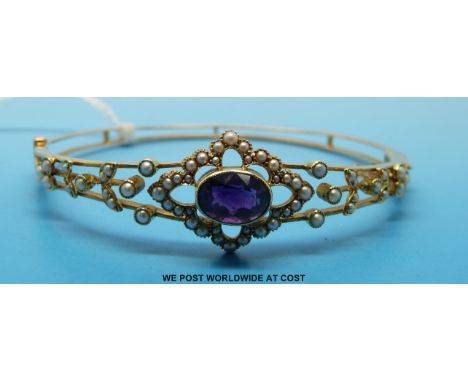 A 15ct gold bangle set with an amethyst and seed pearls 