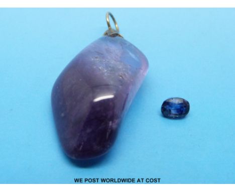 An amethyst pendant and a loose sapphire