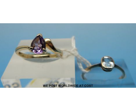 A 9ct gold ring set with a pear cut amethyst and a yellow metal ring set with an aquamarine (size N/M) 