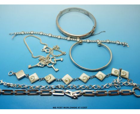 A silver bangle and six silver bracelets