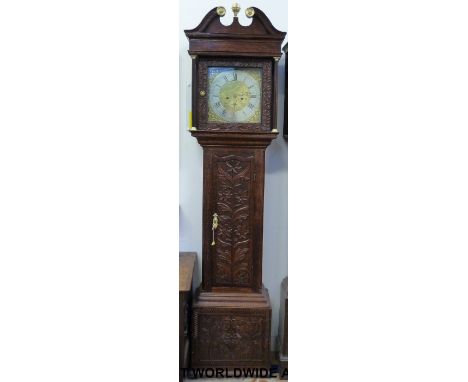 A mid 19thC eight day longcase clock in carved stained oak case, quarter column carved, swan neck pediment, the brass dial wi