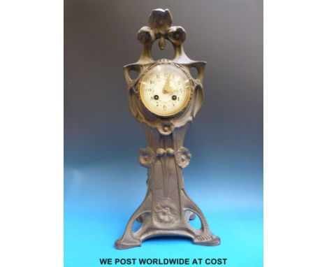 A French Art Nouveau cast metal clock with maker's name stamped to the movement, pierced gilt hands and enamel face